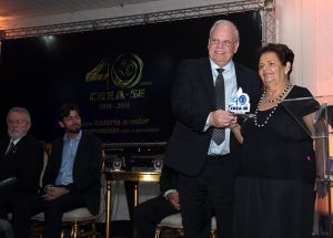 Rita de Cassia recebe o troféu das mãos do presidente da Mútua, Paulo Roberto Guimarães